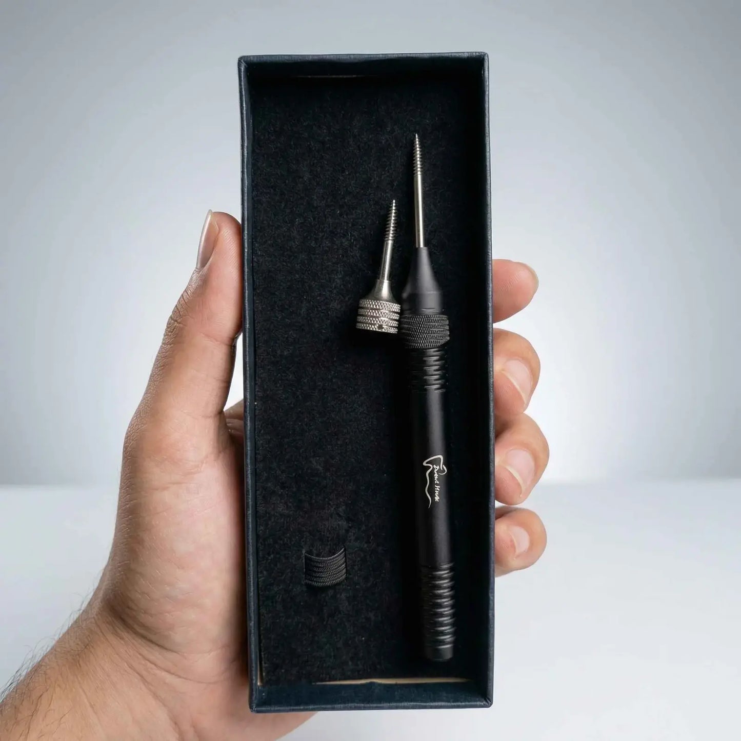 Hand holding a tool in box