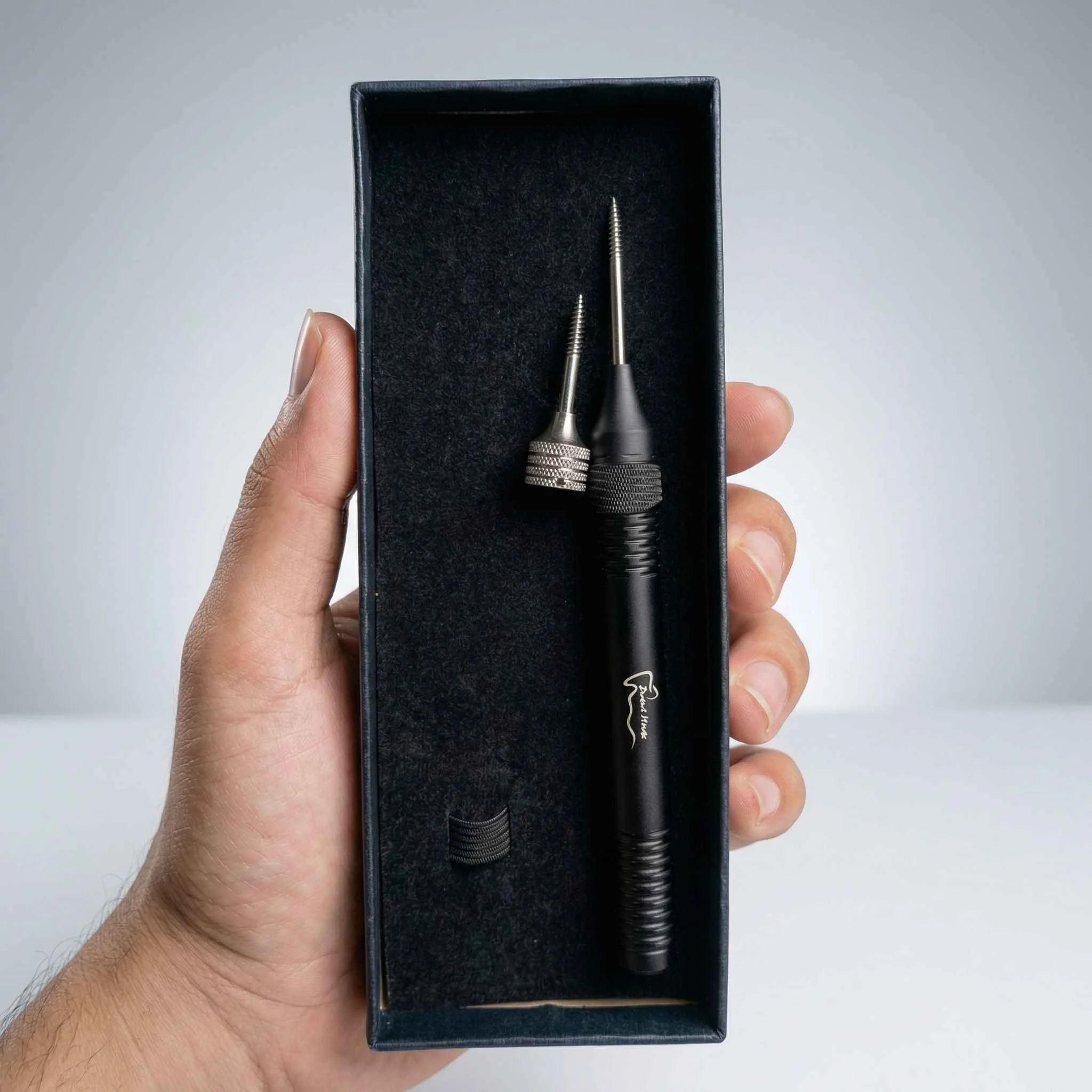 Hand holding a tool in box